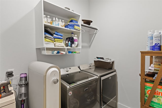 clothes washing area with separate washer and dryer