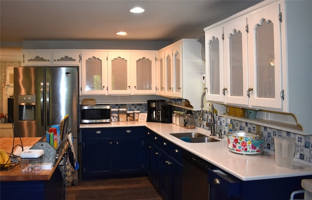 kitchen with blue cabinetry, appliances with stainless steel finishes, decorative backsplash, and white cabinets