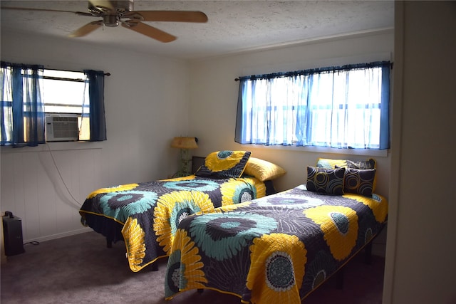 bedroom featuring ceiling fan, multiple windows, carpet floors, and cooling unit