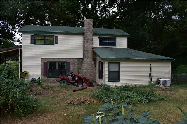 rear view of property featuring ac unit