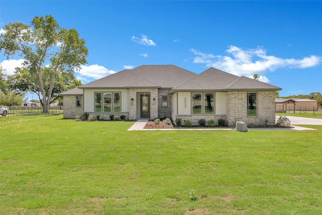 3037 Sunrise Trl, Weatherford, TX 76088 - view of front facade with brick siding, a shingled roof, a front lawn, and fence