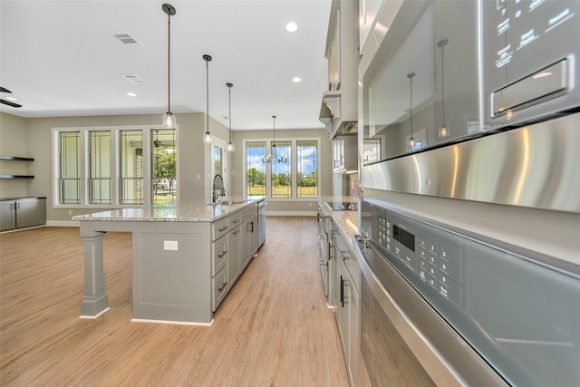 3037 Sunrise Trl, Weatherford, TX 76088 - kitchen with light wood finished floors, visible vents, a breakfast bar, recessed lighting, and a sink