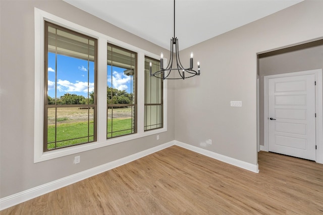 3037 Sunrise Trl, Weatherford, TX 76088 - unfurnished dining area featuring baseboards, light wood-style floors, and an inviting chandelier