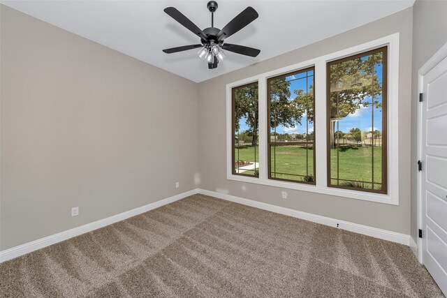 carpeted empty room featuring ceiling fan