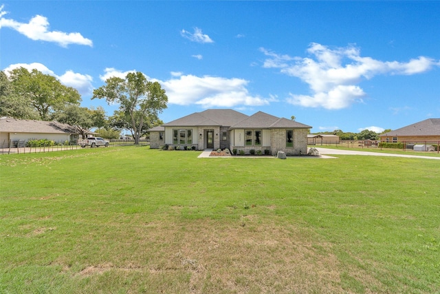 rear view of property with a yard and fence