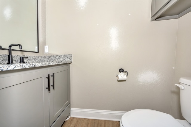 bathroom featuring hardwood / wood-style floors, toilet, and vanity