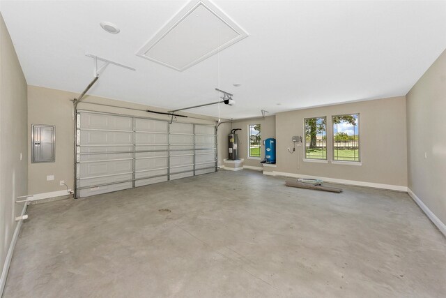 garage with electric panel and a garage door opener