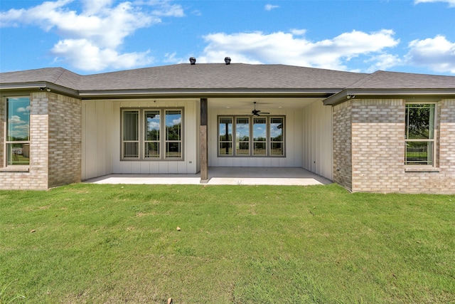 rear view of property featuring a patio area, a yard, and ceiling fan