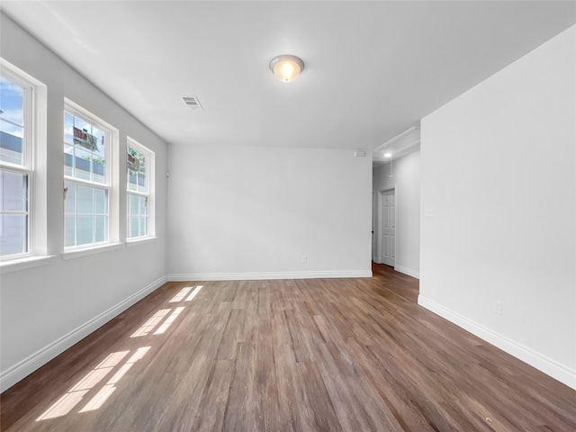 unfurnished room with hardwood / wood-style floors