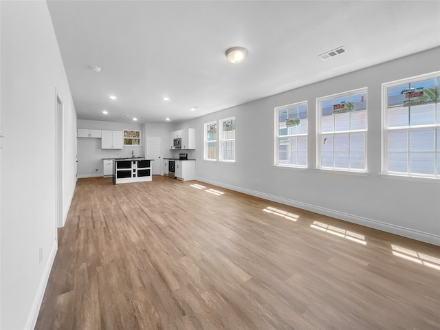 unfurnished living room featuring light hardwood / wood-style flooring