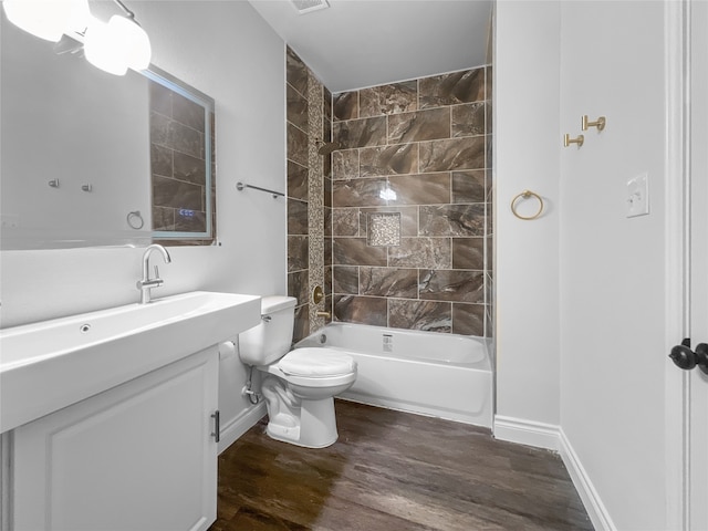 full bathroom with tiled shower / bath, vanity, toilet, and wood-type flooring