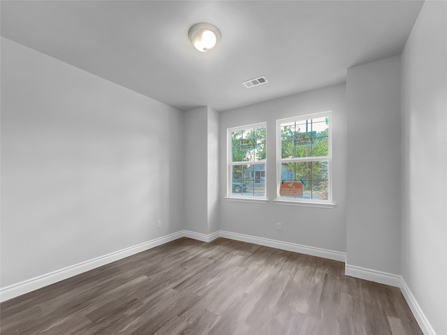 spare room with wood-type flooring