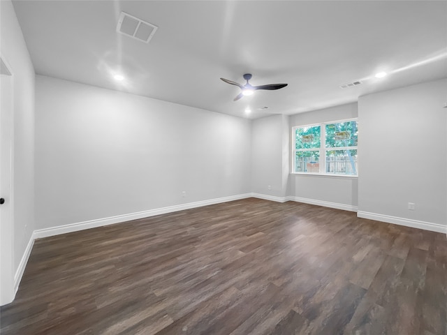 unfurnished room with dark wood-type flooring and ceiling fan