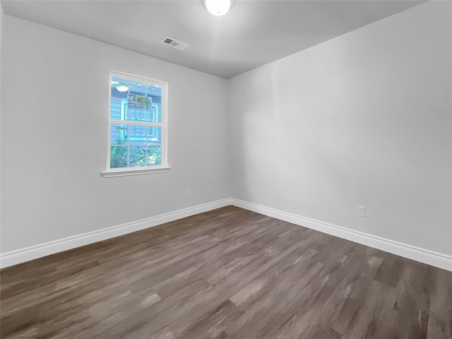 empty room with dark wood-type flooring