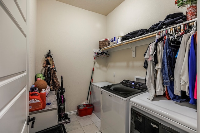 laundry room featuring separate washer and dryer and light tile patterned flooring