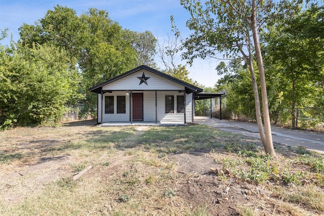 view of front of property with driveway, a porch, and an attached carport