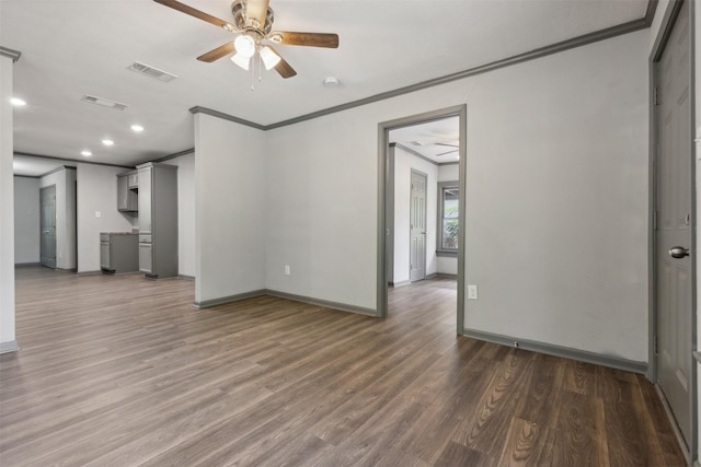 interior space with ceiling fan, wood finished floors, visible vents, and crown molding