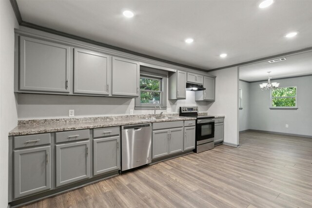 kitchen with crown molding, appliances with stainless steel finishes, a notable chandelier, sink, and gray cabinets