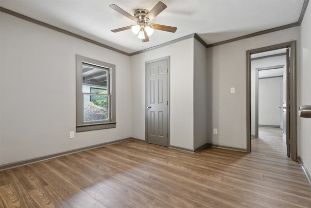 unfurnished bedroom featuring ornamental molding, wood-type flooring, and ceiling fan