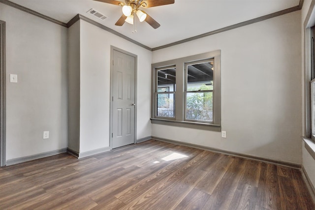 unfurnished bedroom with visible vents, ornamental molding, a ceiling fan, wood finished floors, and baseboards