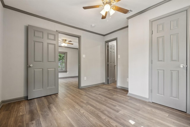 unfurnished bedroom featuring baseboards, ceiling fan, light wood-type flooring, and crown molding