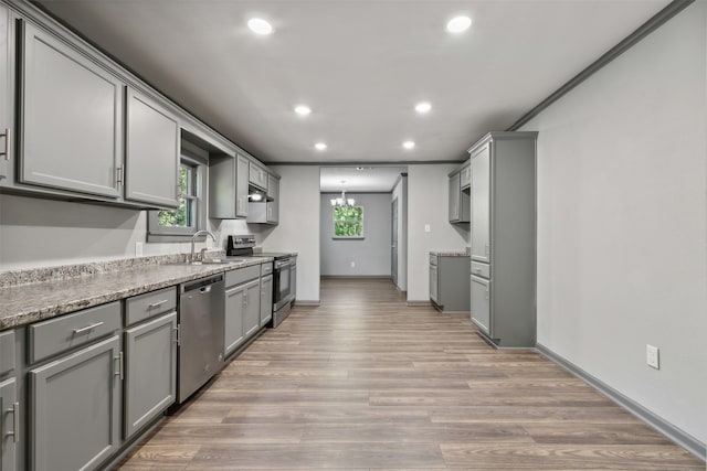 kitchen featuring appliances with stainless steel finishes, gray cabinetry, and light hardwood / wood-style flooring