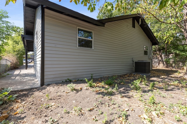 view of property exterior featuring central AC unit and a patio area