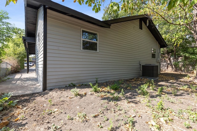 view of home's exterior featuring cooling unit, a patio, and fence