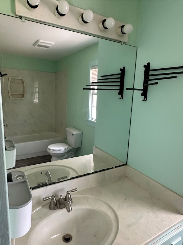 full bathroom with toilet, tiled shower / bath combo, and vanity