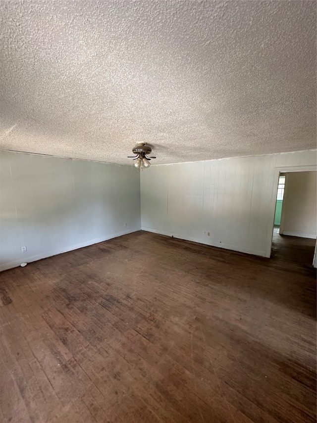 bonus room with dark hardwood / wood-style floors and a textured ceiling