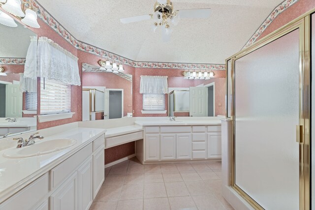 bathroom with ceiling fan, walk in shower, a textured ceiling, and vanity