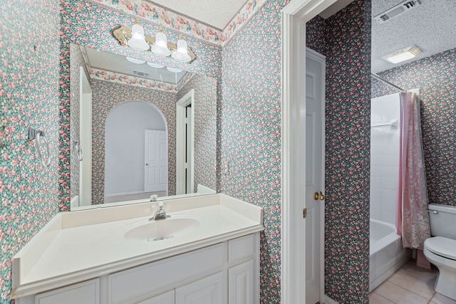 full bathroom featuring a textured ceiling, vanity, tile patterned flooring, toilet, and shower / bath combo