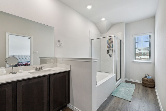 bathroom with vanity, separate shower and tub, and hardwood / wood-style floors