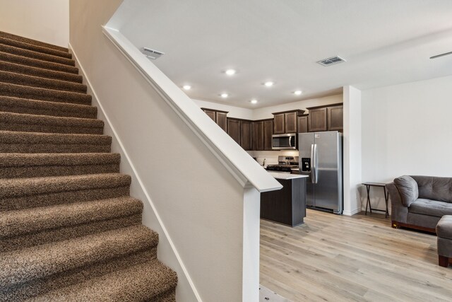 stairs with hardwood / wood-style floors