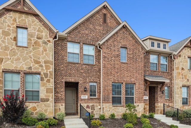 multi unit property with stone siding and brick siding