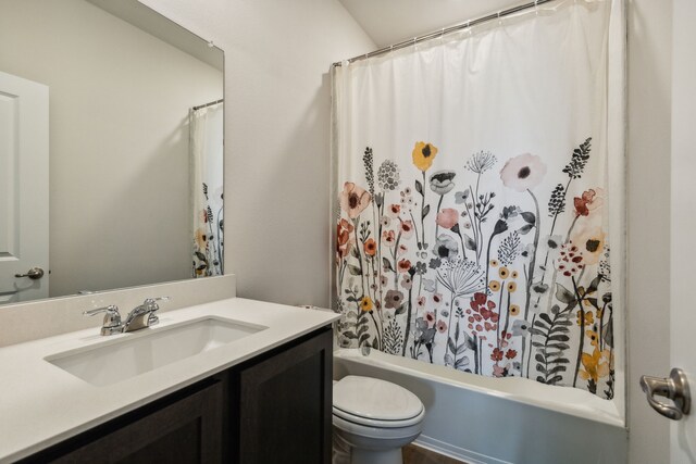 full bathroom with vanity, toilet, and shower / tub combo with curtain