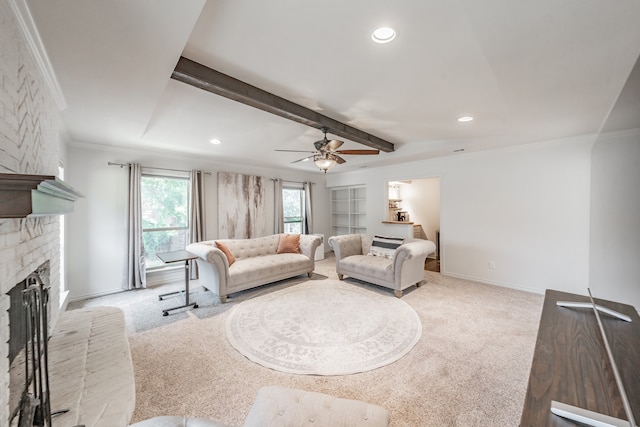 living area featuring a brick fireplace, carpet flooring, crown molding, and beam ceiling