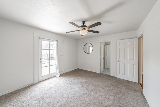 unfurnished bedroom featuring ceiling fan and carpet flooring