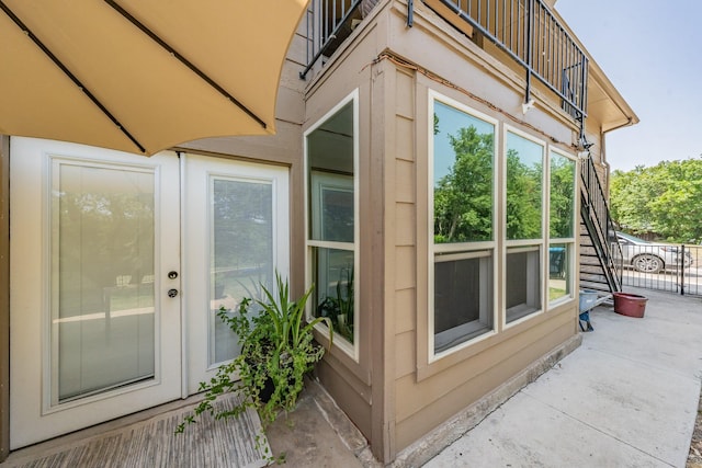 view of side of home featuring a balcony