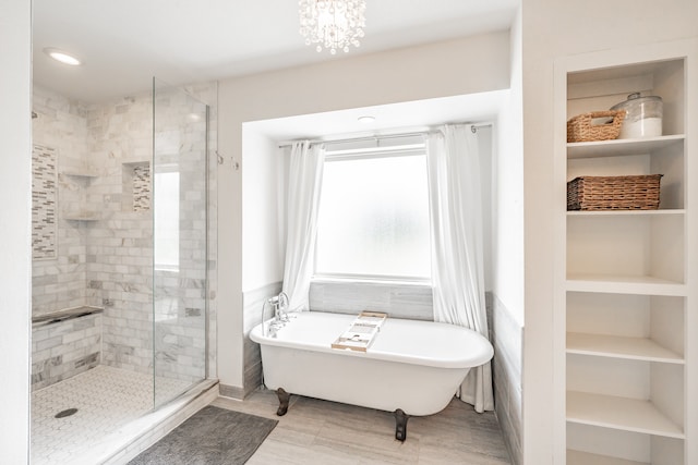 bathroom featuring hardwood / wood-style flooring, independent shower and bath, a notable chandelier, and built in shelves