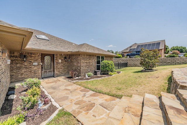 property entrance featuring a patio and a lawn