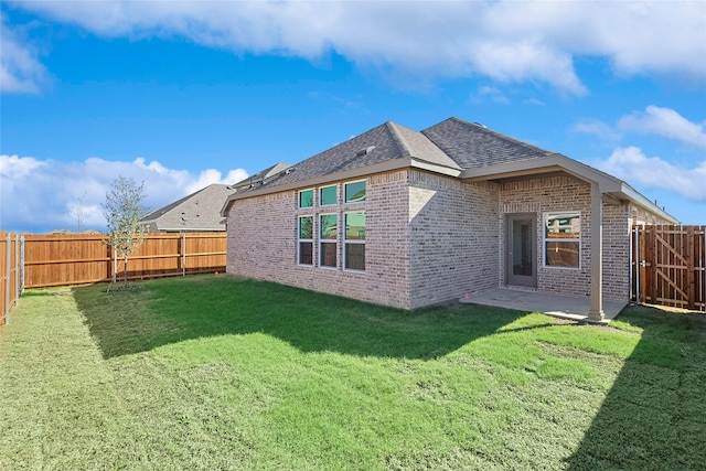 rear view of property with a patio area and a lawn