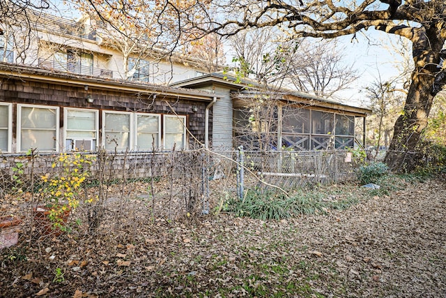 view of property exterior with a sunroom