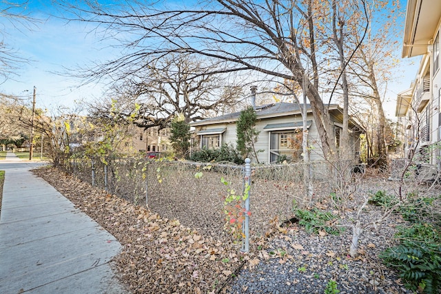 view of side of property featuring fence