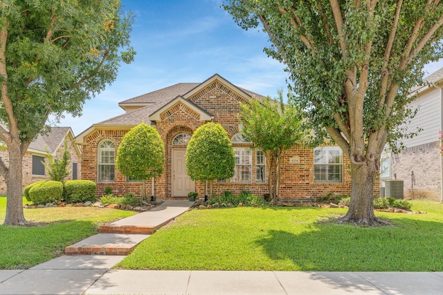 view of front of property with cooling unit and a front yard