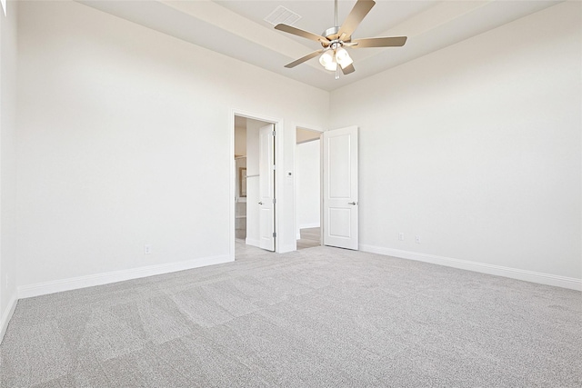 spare room with ceiling fan and light carpet