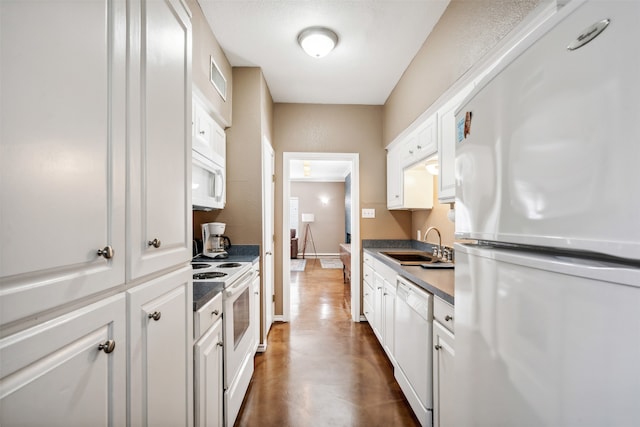 kitchen featuring white cabinetry, sink, and white appliances