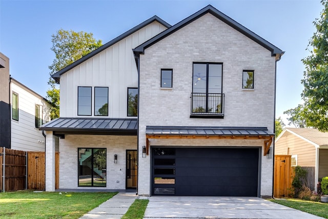 modern farmhouse style home featuring a standing seam roof, fence, board and batten siding, an attached garage, and brick siding