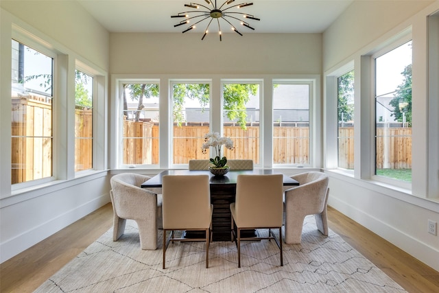 sunroom with an inviting chandelier