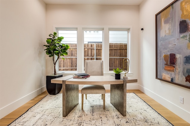 home office with light hardwood / wood-style floors